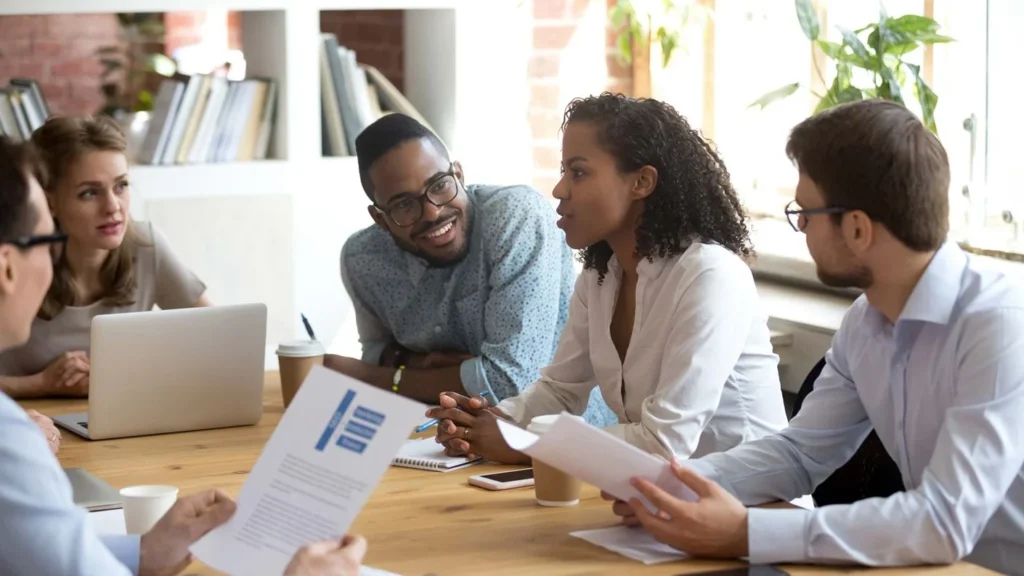 group-of-professionals-discussing-and-collaborating-around-a-table-in-an-office-setting-with-focus-on-Technical-SEO