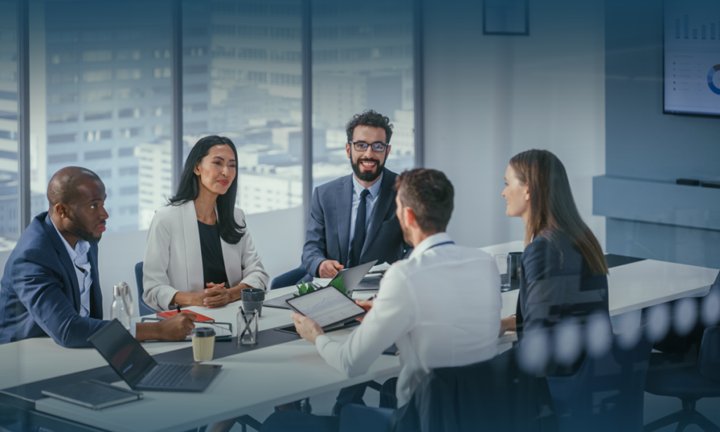 diverse-professional-team-smiling-and-discussing-during-meeting-in-modern-office