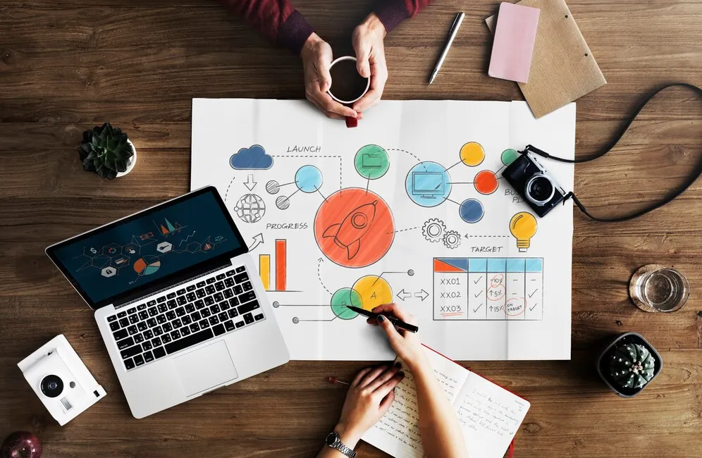 hands-working-on-strategy-illustration-with-laptop-coffee-and-documents