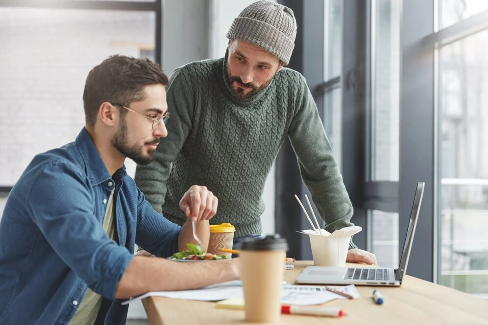 two-people-discussing-seo-laptop-office