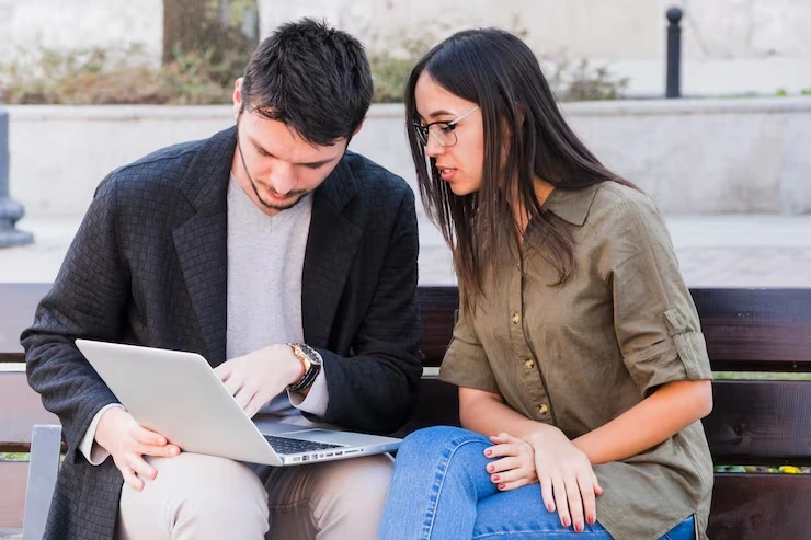 SEO professionals reviewing HTTPS settings and redirect configurations on a laptop during a technical SEO consultation.