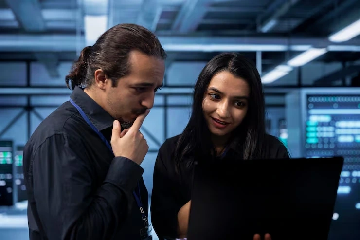 Two WordPress SEO Experts reviewing security settings on a laptop, representing security and HTTPS configuration.